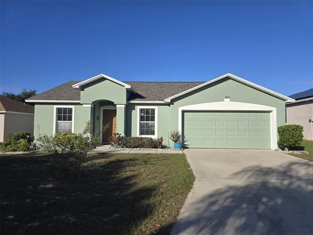 a front view of a house with a garden and yard