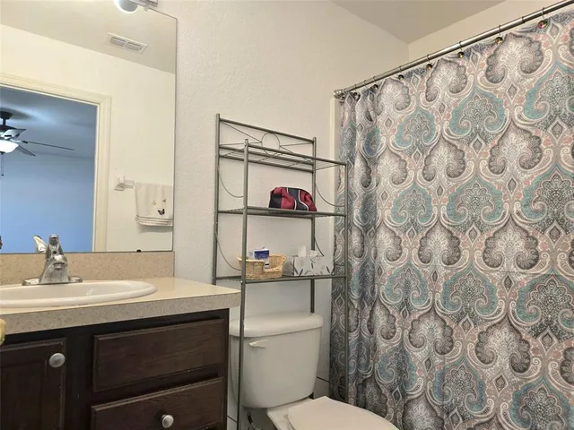 a bathroom with a sink toilet and a mirror