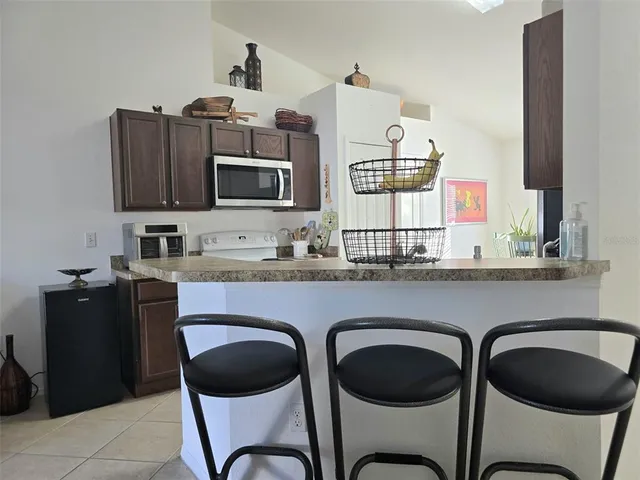 a kitchen with stainless steel appliances granite countertop a stove and a microwave