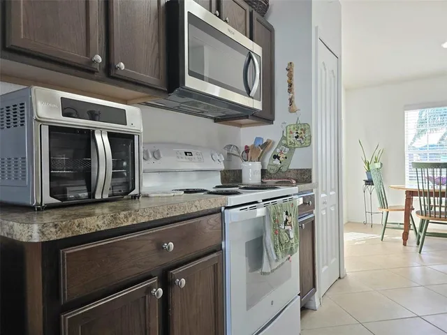 a kitchen with stainless steel appliances a stove microwave and sink