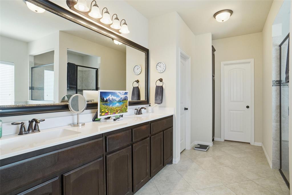 106 High Ridge Court Decatur, TX 76234 - Photo 12 of 19 a bathroom with a double vanity sink and mirror