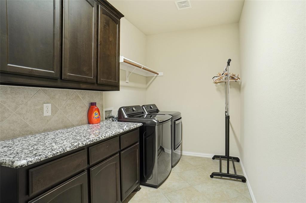 106 High Ridge Court Decatur, TX 76234 - Photo 17 of 19 a kitchen with granite countertop a sink stainless steel appliances and cabinets