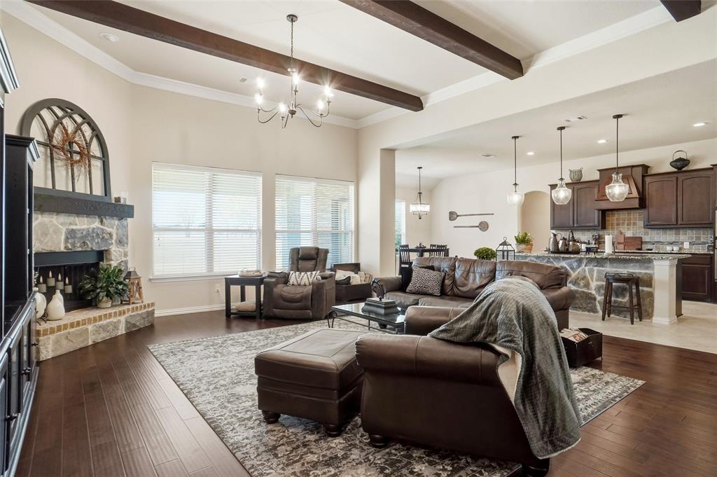 106 High Ridge Court Decatur, TX 76234 - Photo 4 of 19 a living room with furniture a fireplace and a chandelier