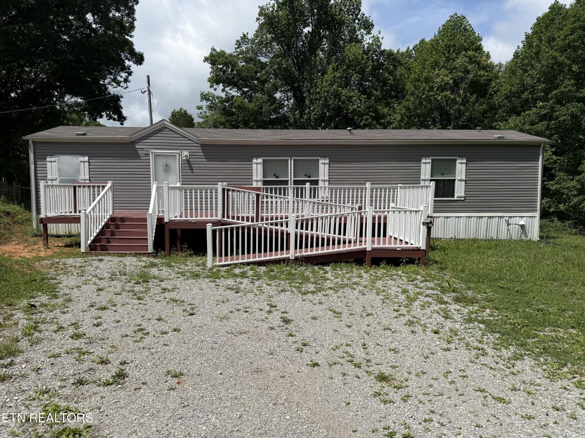 1366 Pearl Hinds Road Jamestown, TN 38556 - Photo 2 of 16 a view of a house with a yard and wooden fence