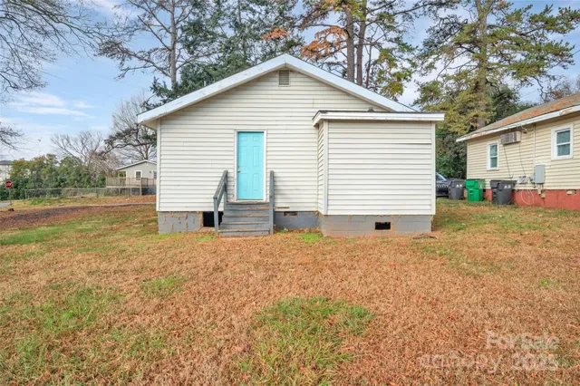 a view of backyard of house with outdoor seating