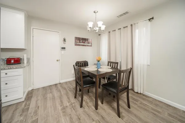 a view of a dining room with furniture and wooden floor