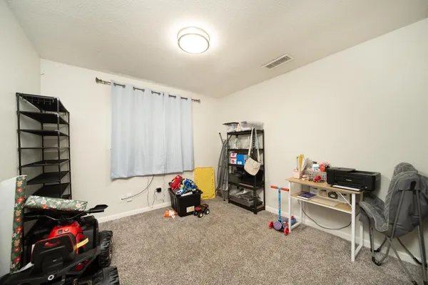 a view of a room with workspace and a window