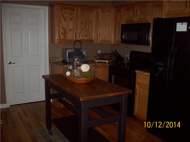 203 Mai Ridge Lane Lafayette, TN 37083 - Photo 3 of 8 Beautiful kitchen w/ lots of cabinets and hardwood.