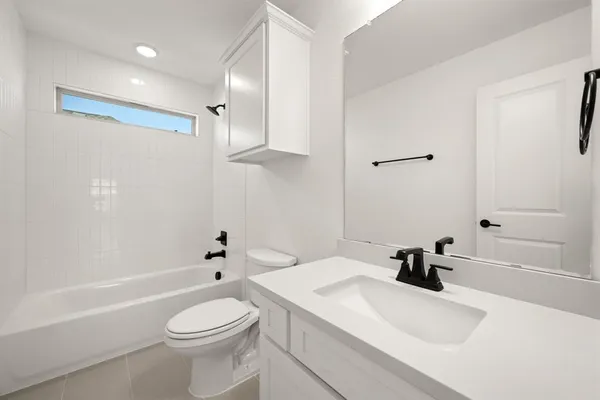 a bathroom with a sink a toilet and a bathtub