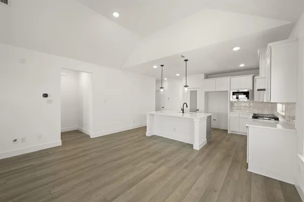 a view of kitchen with wooden floor and electronic appliances