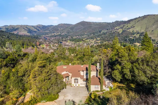 an aerial view of a house with mountain view