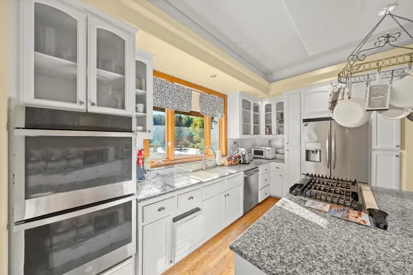 a kitchen with cabinets appliances and a counter top space