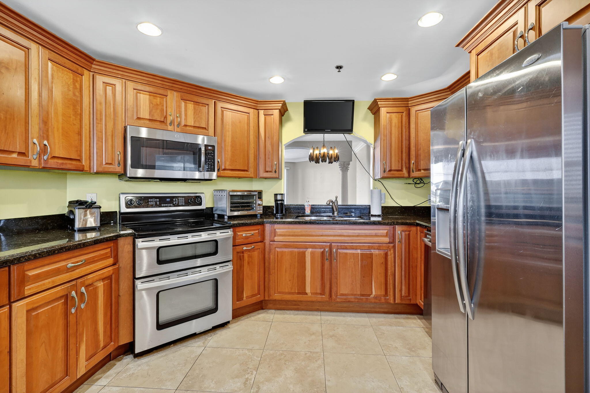 1035 South Federal Highway, Unit PH3 39 Delray Beach, FL 33483 - Photo 16 of 44 a kitchen with stainless steel appliances granite countertop a refrigerator a stove top oven a sink and dishwasher