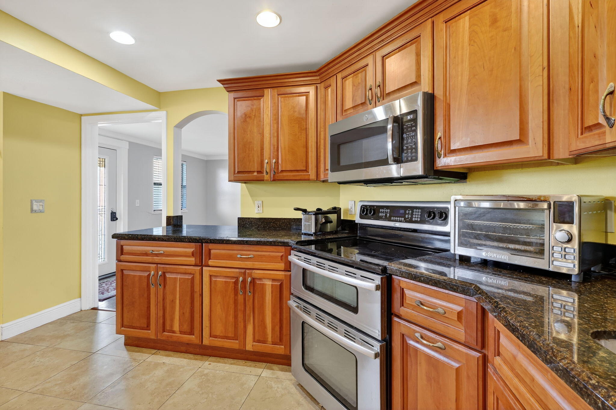 1035 South Federal Highway, Unit PH3 39 Delray Beach, FL 33483 - Photo 17 of 44 a kitchen with stainless steel appliances granite countertop a stove a sink and a microwave