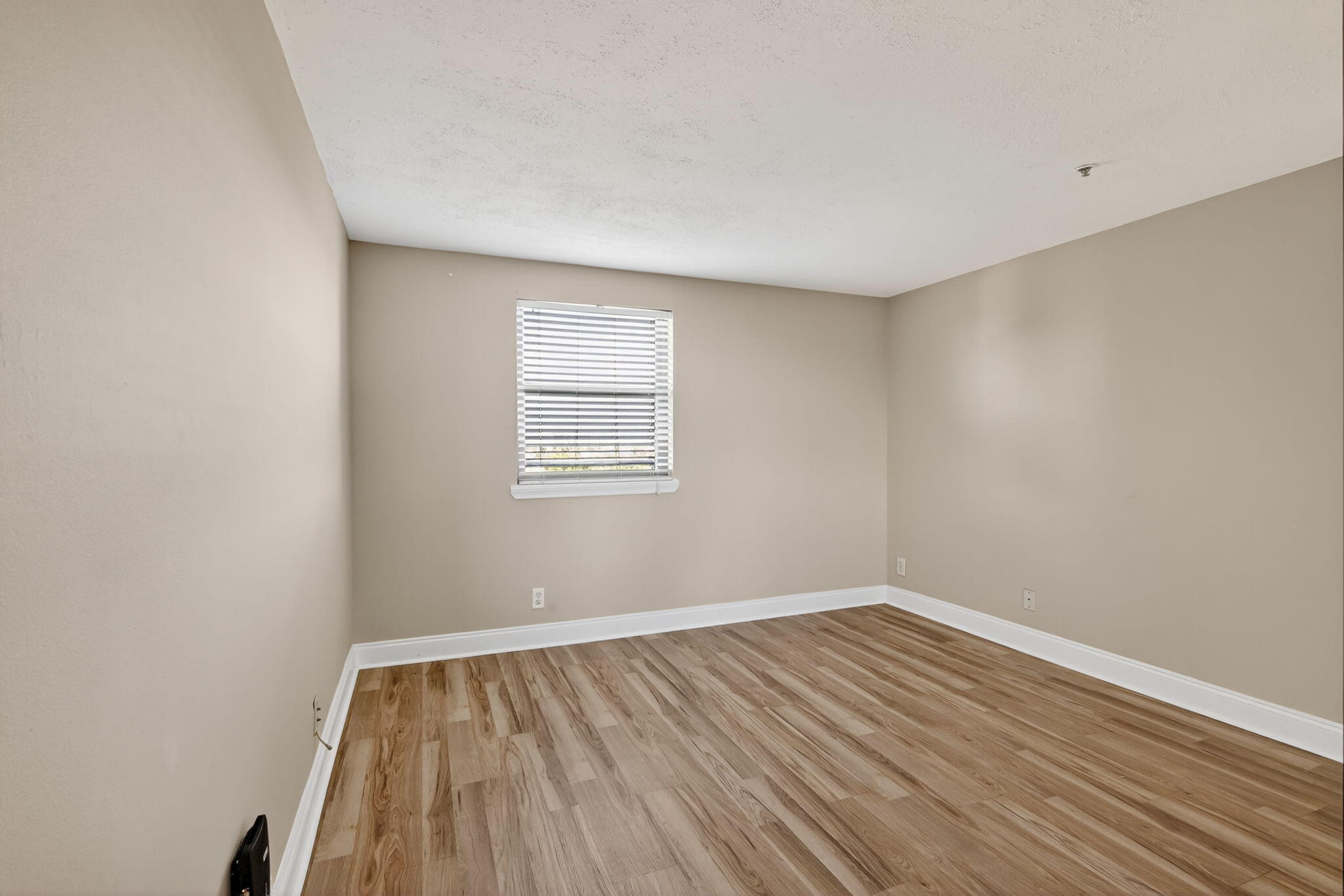 1035 South Federal Highway, Unit PH3 39 Delray Beach, FL 33483 - Photo 25 of 44 an empty room with wooden floor and windows
