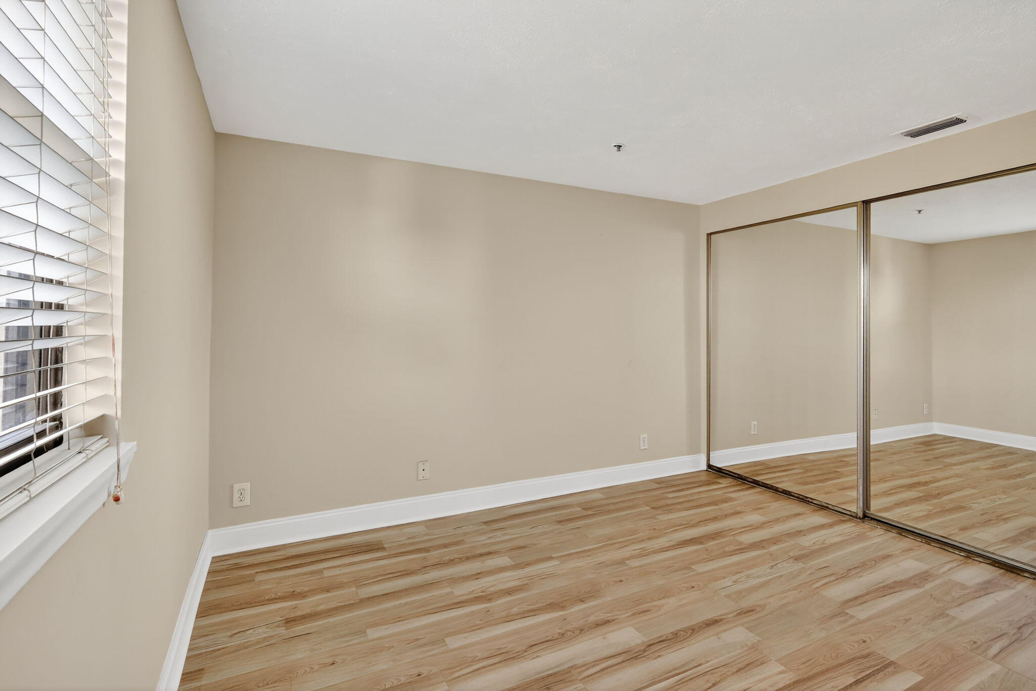 1035 South Federal Highway, Unit PH3 39 Delray Beach, FL 33483 - Photo 26 of 44 a view of an empty room with wooden floor and a window