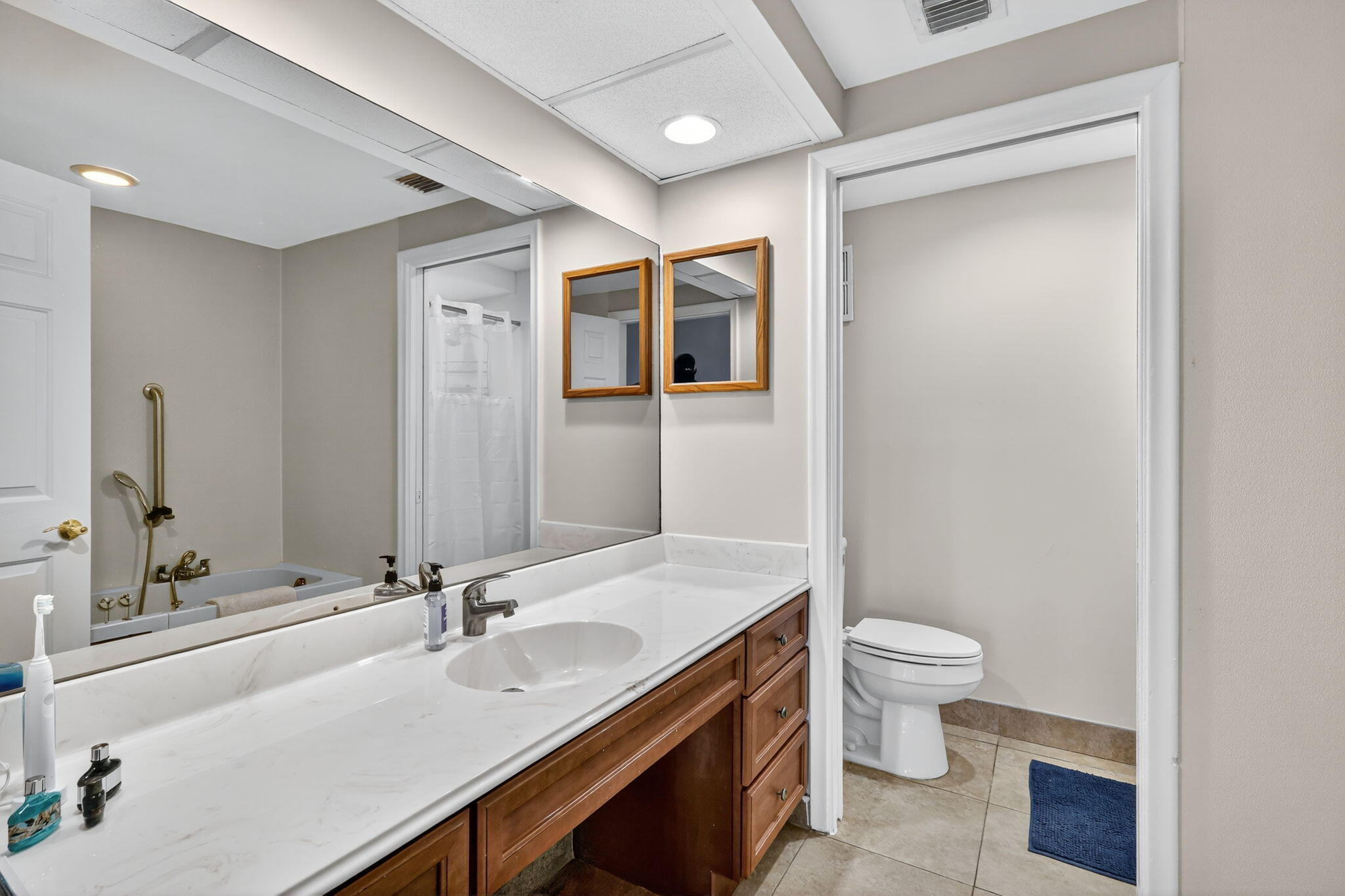 1035 South Federal Highway, Unit PH3 39 Delray Beach, FL 33483 - Photo 28 of 44 a bathroom with a sink a toilet and a large mirror