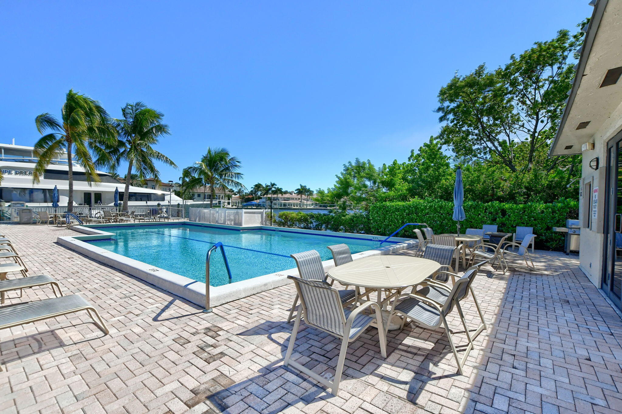 1035 South Federal Highway, Unit PH3 39 Delray Beach, FL 33483 - Photo 37 of 44 a view of a swimming pool with a patio and a yard