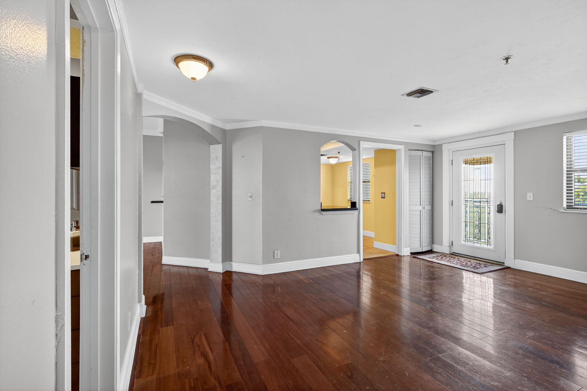1035 South Federal Highway, Unit PH3 39 Delray Beach, FL 33483 - Photo 9 of 44 an empty room with wooden floor and windows