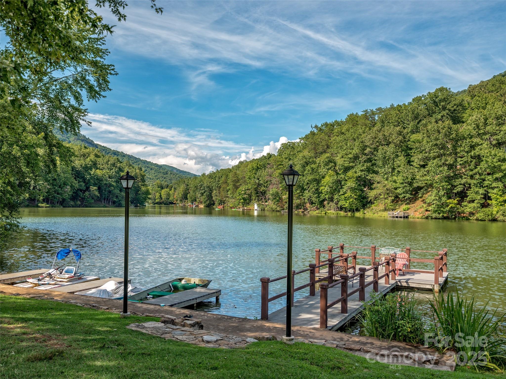 0 High Rock Ridge, Unit 22 Lake Lure, NC 28746 - Photo 10 of 15 a view of a lake with couches and wooden fence