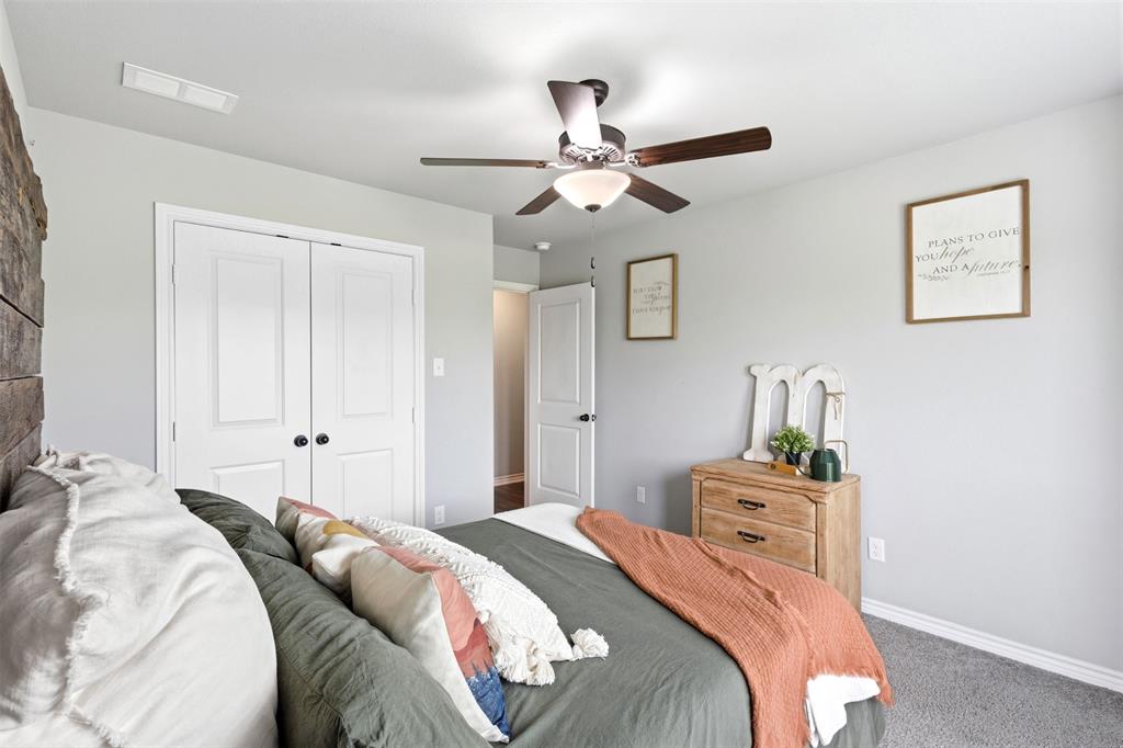 2990 Wilson Road Palmer, TX 75152 - Photo 24 of 40 a bedroom with a bed and a chandelier