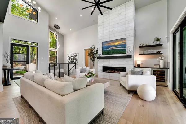 a kitchen with stainless steel appliances granite countertop a stove a sink dishwasher and a dining table with wooden floor