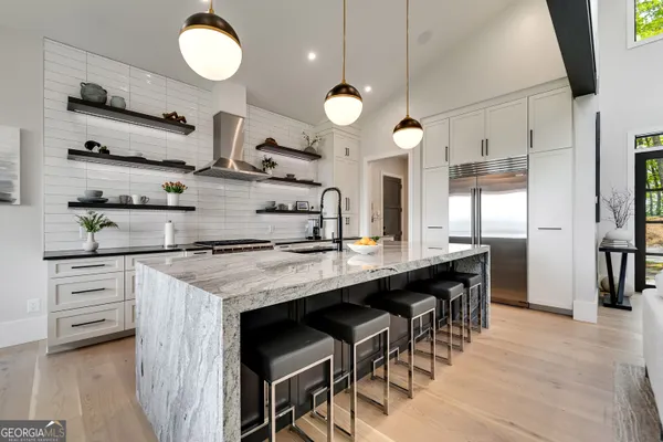 a kitchen with stainless steel appliances granite countertop a stove and a microwave