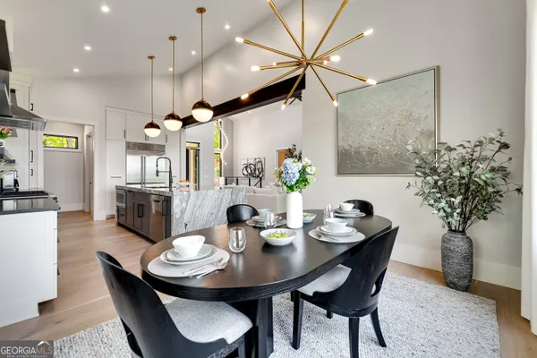 a bedroom with a bed a chandelier and a large window