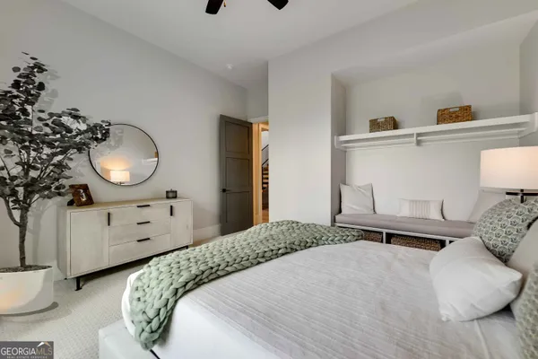 a bedroom with a bed a desk and chair with a bookshelf