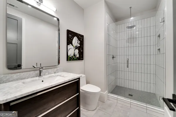 a bathroom with a tub double vanity sink and mirror