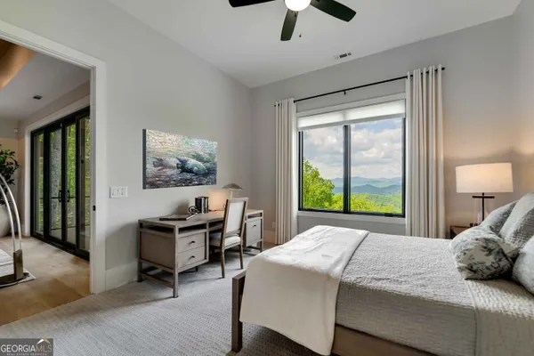 a spacious bedroom with a bed and a window
