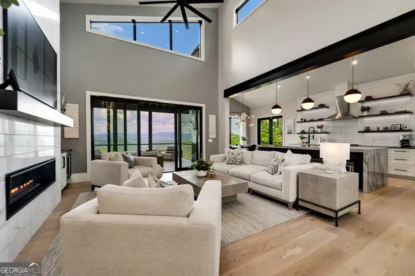 a living room with furniture a fireplace and a flat screen tv