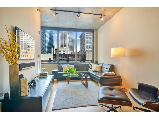 235 West Van Buren Street, Unit 1616 Chicago, IL 60607 - Photo 2 of 16 a living room with furniture and a large window