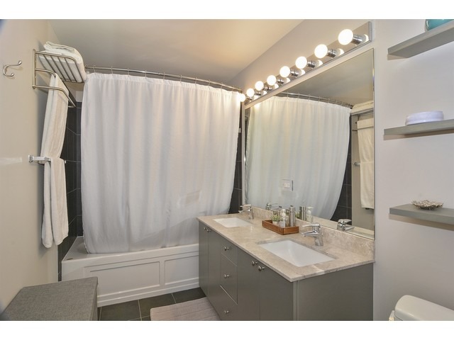 235 West Van Buren Street, Unit 1616 Chicago, IL 60607 - Photo 11 of 16 a bathroom with a sink vanity granite tub and shower