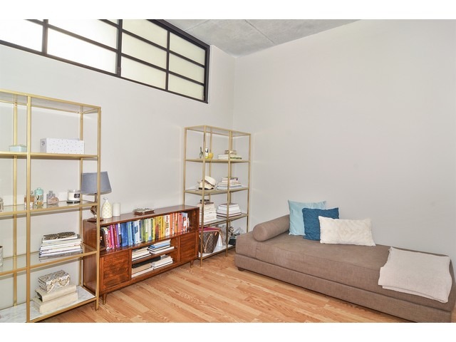 235 West Van Buren Street, Unit 1616 Chicago, IL 60607 - Photo 12 of 16 a living room with furniture and a book shelf