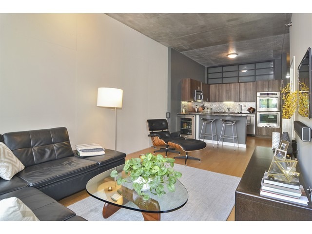 235 West Van Buren Street, Unit 1616 Chicago, IL 60607 - Photo 3 of 16 a living room with furniture and a wooden floor