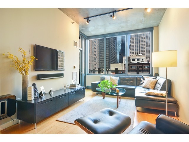235 West Van Buren Street, Unit 1616 Chicago, IL 60607 - Photo 5 of 16 a living room with furniture and a flat screen tv