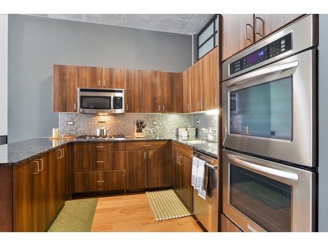 235 West Van Buren Street, Unit 1616 Chicago, IL 60607 - Photo 6 of 16 a kitchen with stainless steel appliances a stove microwave and sink