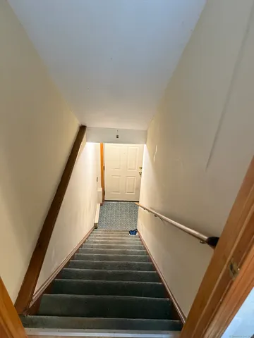 a kitchen with stainless steel appliances kitchen island granite countertop a stove a sink and a refrigerator