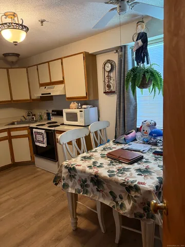 a kitchen with stainless steel appliances a sink a stove a refrigerator and cabinets