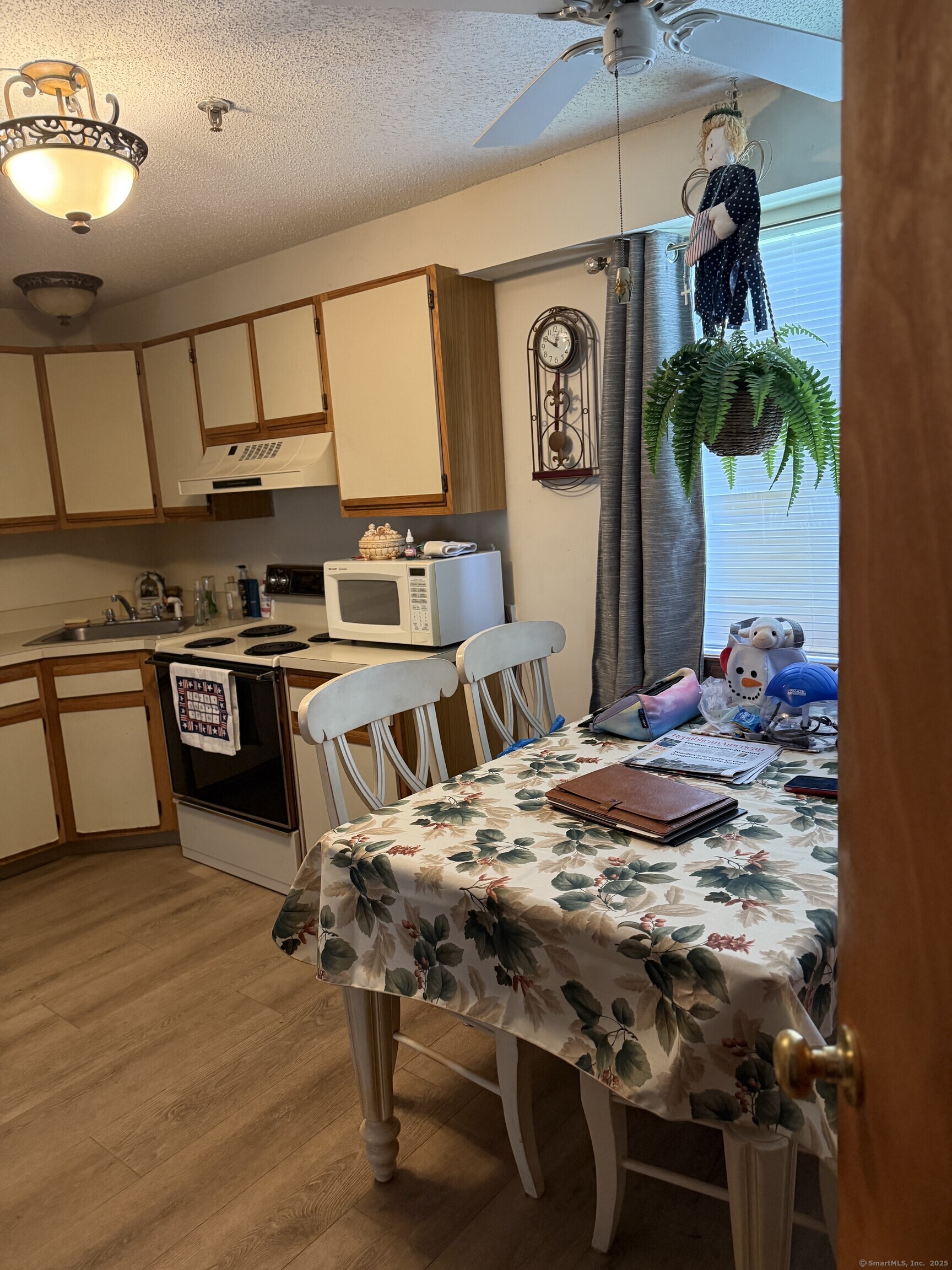 531 Meriden Road, Unit 2 Waterbury, CT 06705 - Photo 5 of 13 a kitchen with stainless steel appliances kitchen island granite countertop a stove a sink and a refrigerator