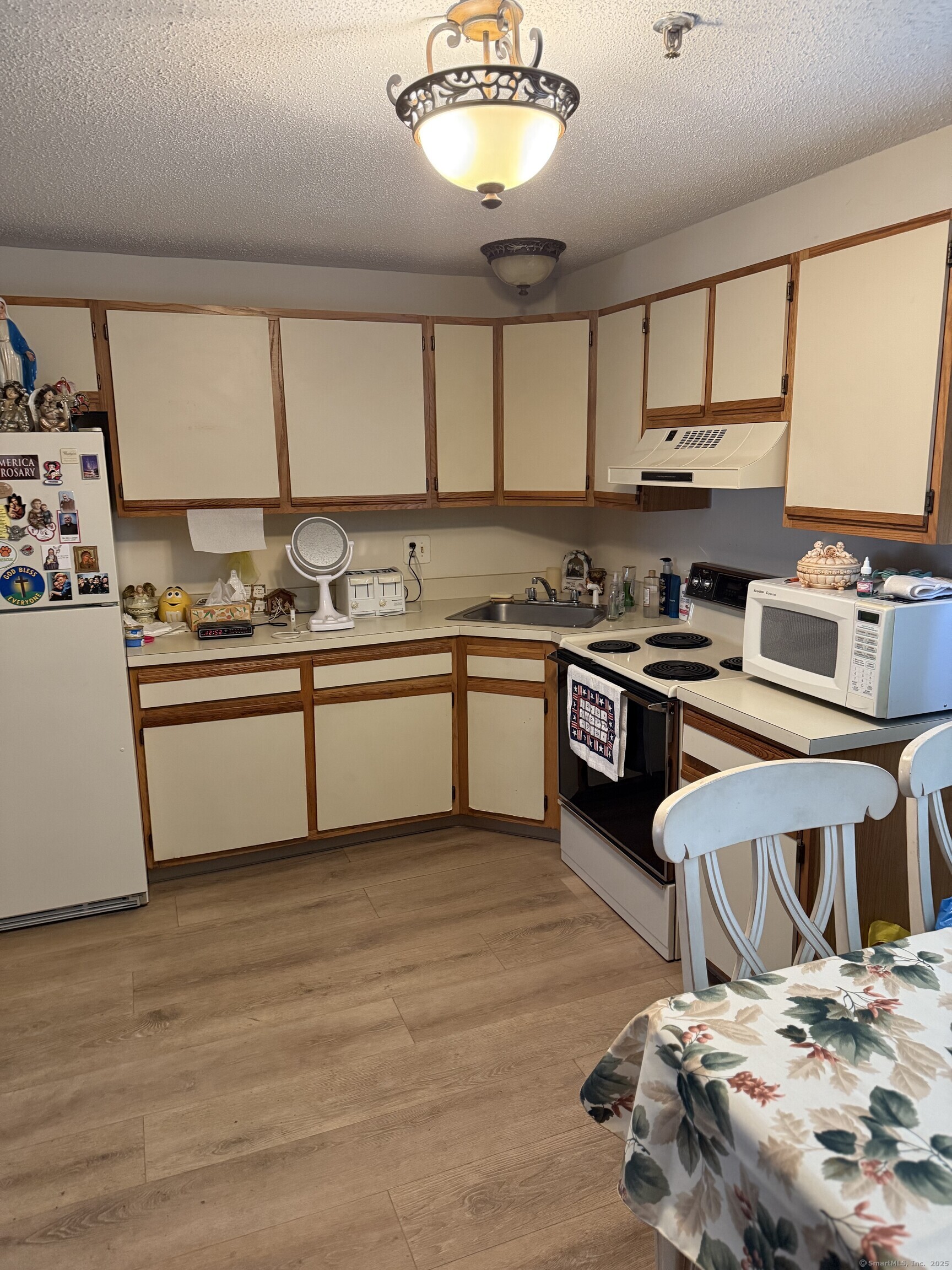 531 Meriden Road, Unit 2 Waterbury, CT 06705 - Photo 6 of 13 a kitchen with stainless steel appliances a sink a stove a refrigerator and cabinets