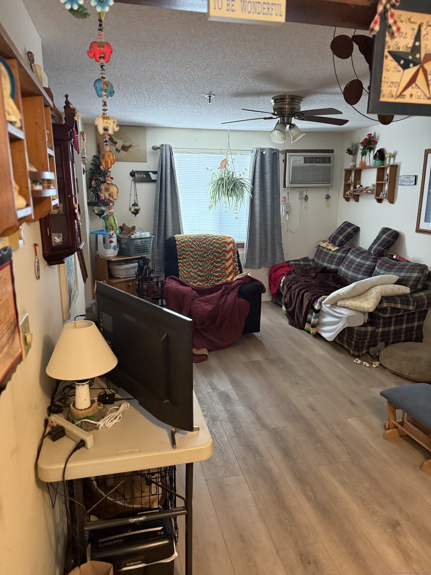 531 Meriden Road, Unit 2 Waterbury, CT 06705 - Photo 7 of 13 a bedroom with furniture and a lamp