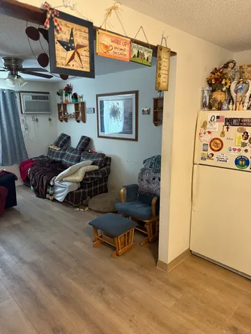 a living room with furniture and kitchen view