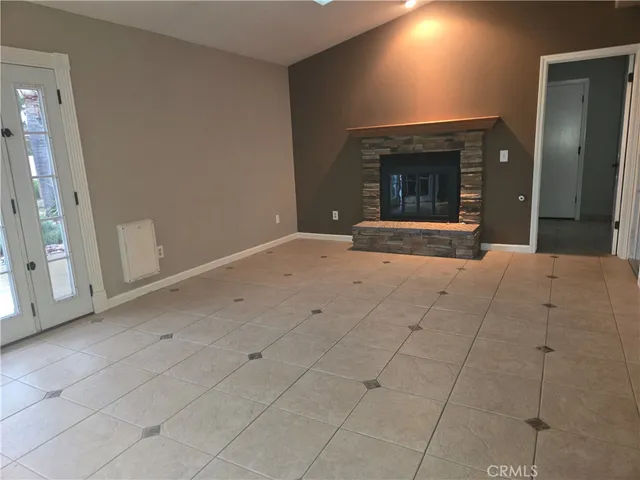 a view of an empty room with a fireplace