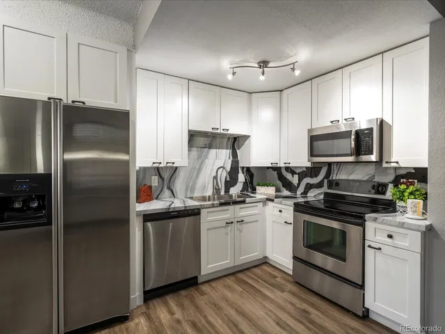 a kitchen with stainless steel appliances and wooden cabinets