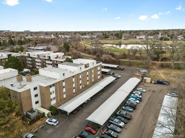 a couple of cars parked in front of a building