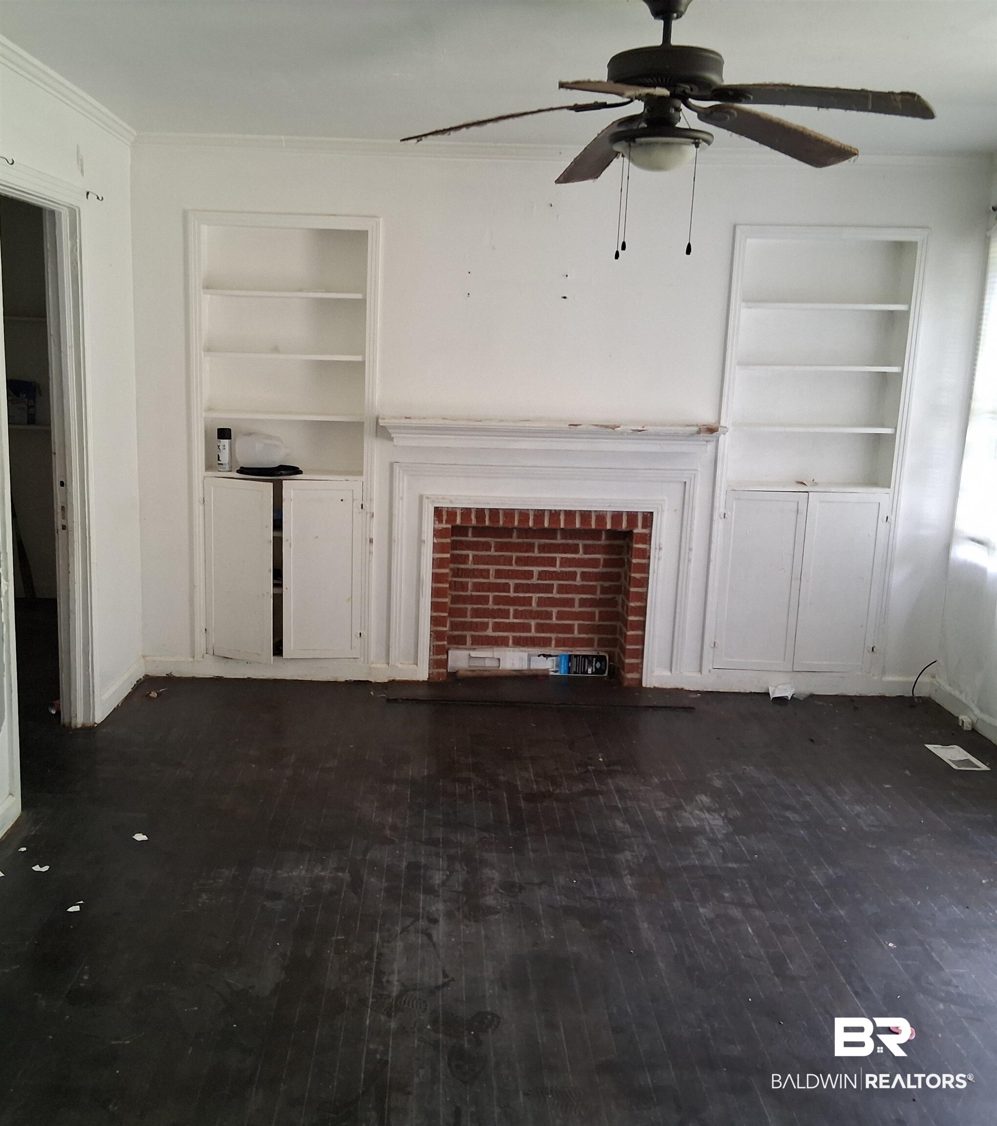 403 Bruner Avenue Evergreen, AL 36401 - Photo 2 of 9 Central brick fireplace with a painted wood mantelpiece