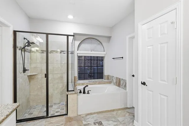 a bathroom with a bathtub and a shower