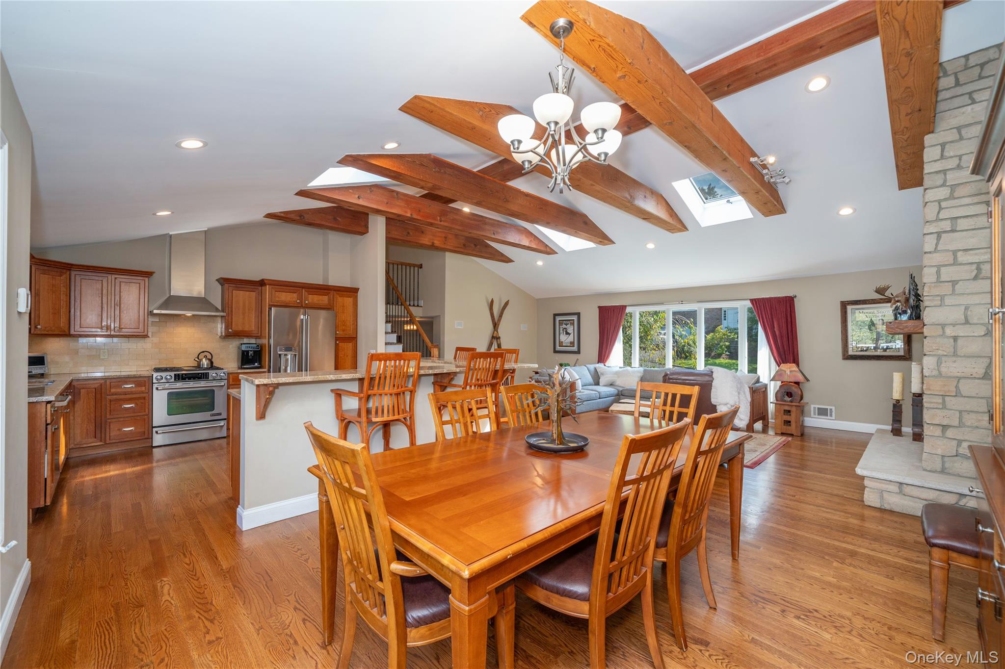 53 Tarryhill Road Tarrytown, NY 10591 - Photo 12 of 35 The dining area flows seamlessly into the dramatic living room, highlighting the home's open layout and easy connection between spaces.